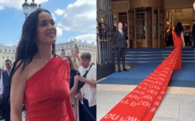 Katy Perry usa vestido com cauda gigante, estampada com a letra de seu novo single, “Woman’s World”